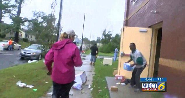  Footage showed people carrying items out of the store as the storm hit