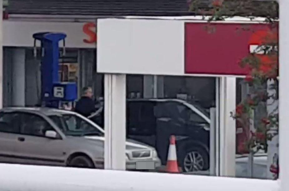  Exasperated, he heads into the shop after being told there's no petrol at pump one either