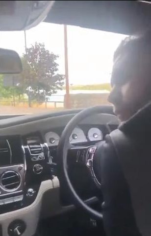  The champion boxer sat at the wheel of his car, mocking the vulnerable lady