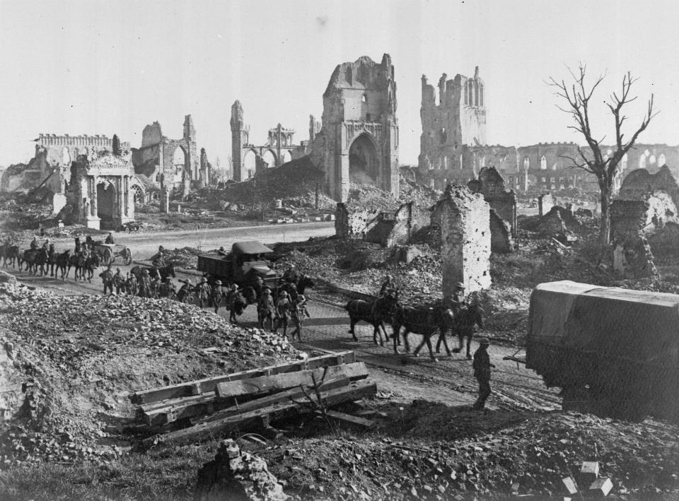  Horses and men of 1st Anzac Corps on their way past the ruins of the Cathedral and Cloth Hall in Ypres