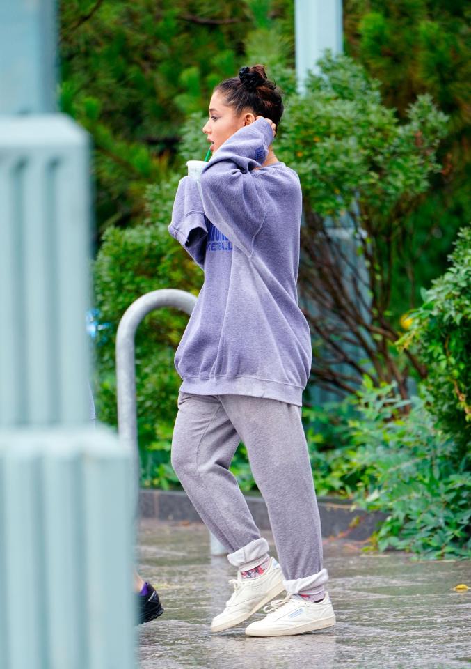  Her oversized Knicks jumper got soaked in the downpour, but she didn't seem to mind