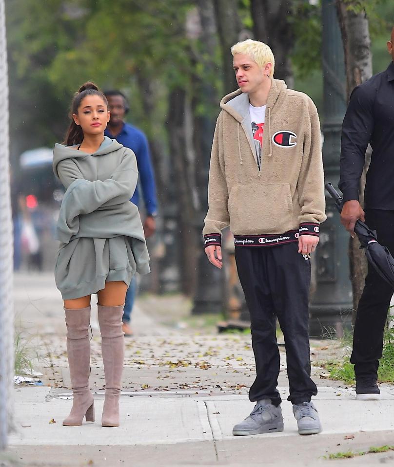  Ariana wore a trademark oversized hoodie with over the knee suede boots