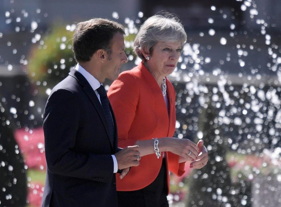  Theresa May in deep discussion in Salzburg with the French President Emmanuel Macron