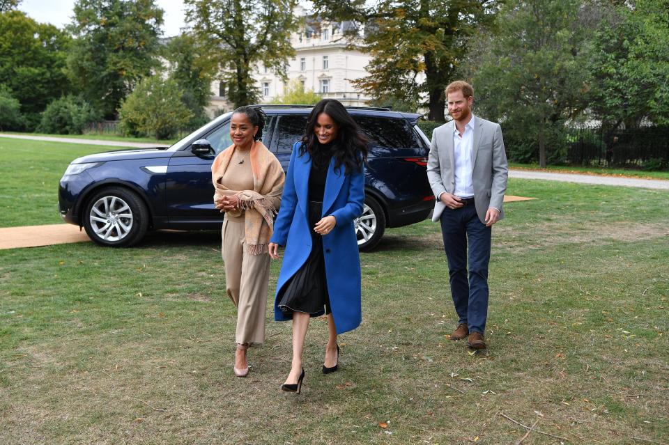  Harry takes a step back as Meghan and Doria stride towards the waiting guests