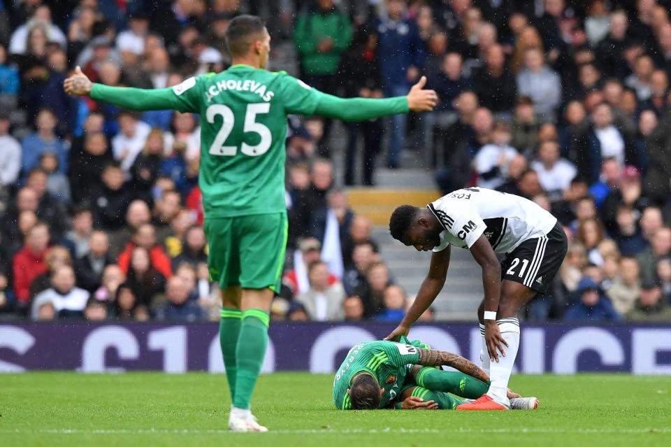  The Fulham player checks on Deeney after his horror lunge