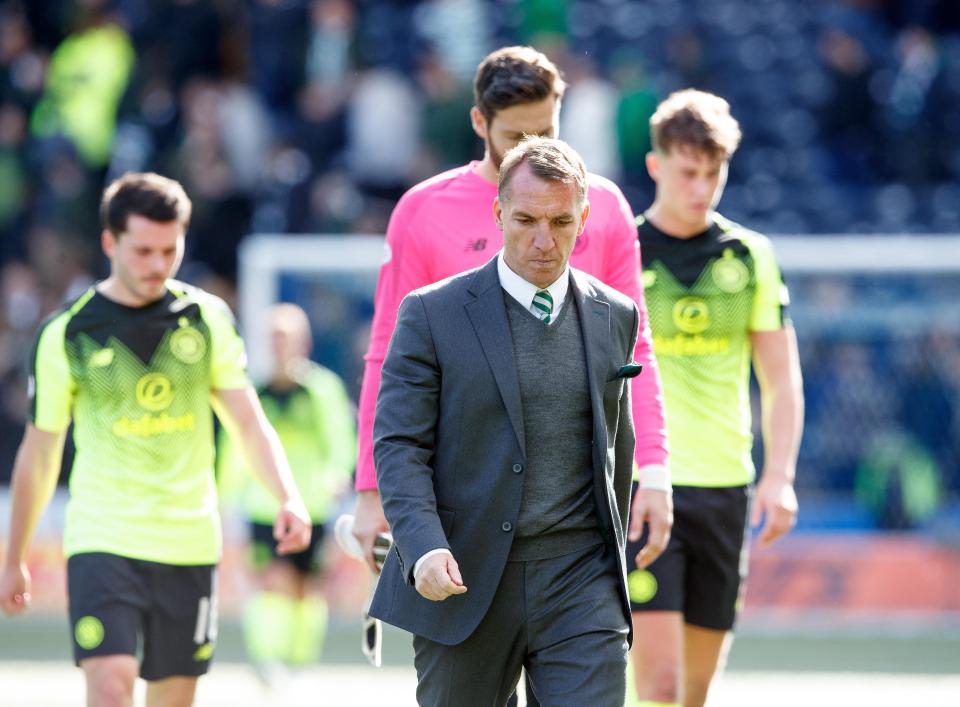  Brendan Rodgers and his players trudge off the field after another shock defeat