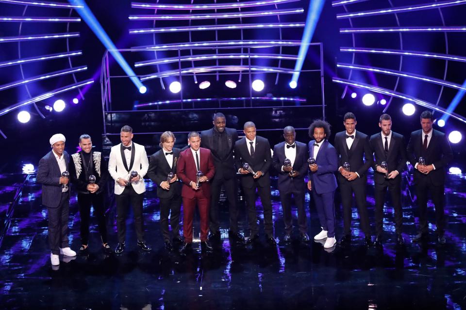  Actor Idris Elba stands with the FIFA team of the year