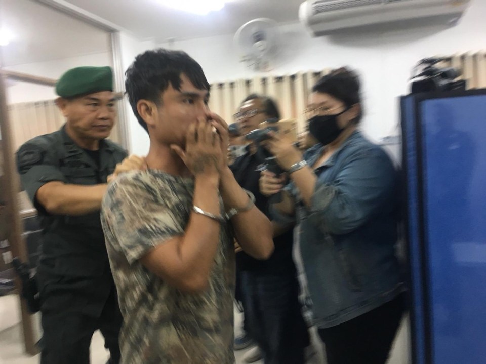 Fellow suspect Kittipong Kamwan, 24, arrives at the police station