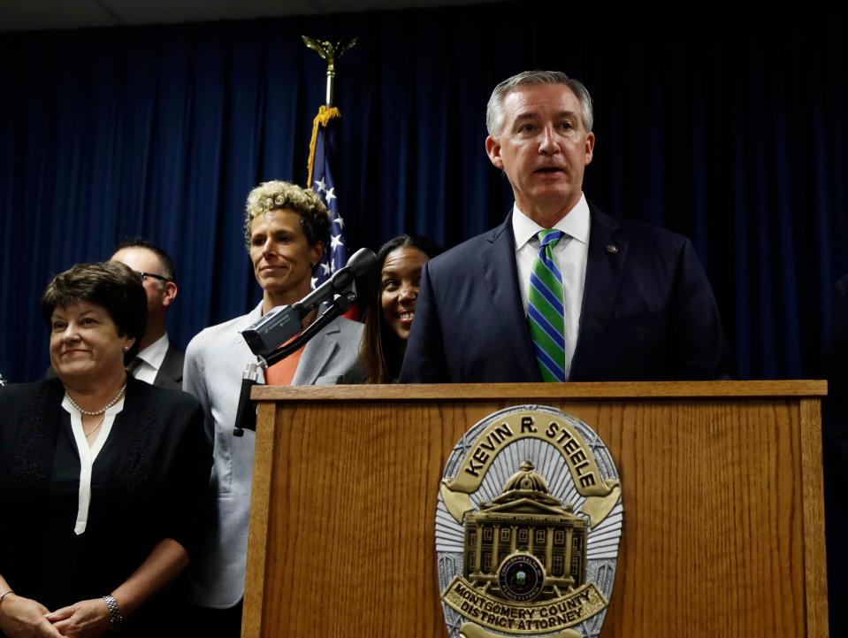  Andrea Constand, centre left, stands behind Montgomery County District Attorney Kevin Steele