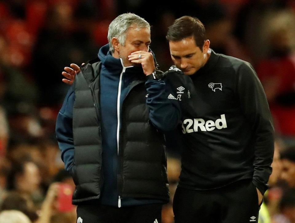  Jose Mourinho whispers into Frank Lampard's ear on the touchline