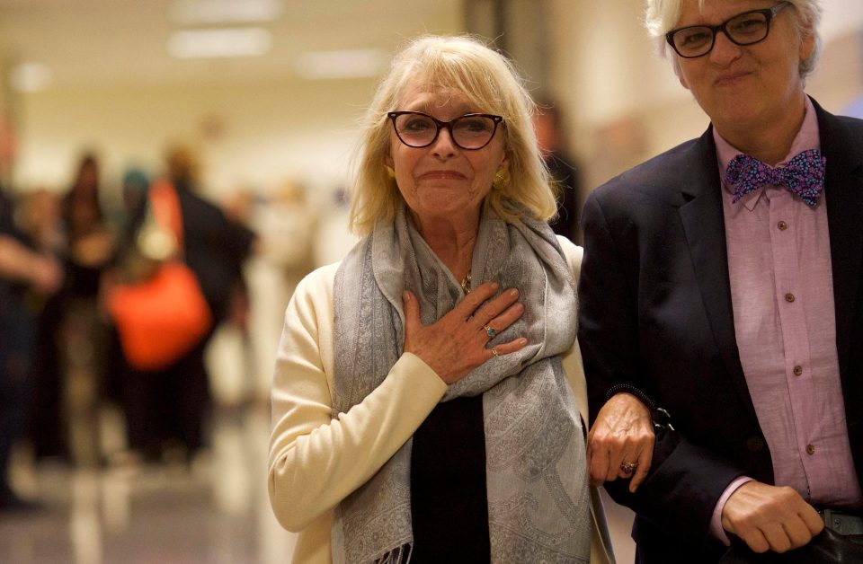  Fellow accuser Victoria Valentino, left, holds her hand to her heart and smiles as Cosby was sentenced