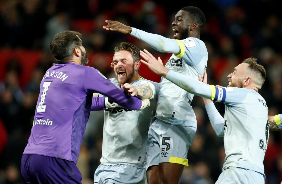  Scott Carson is congratulated by his team-mates after his penalty save