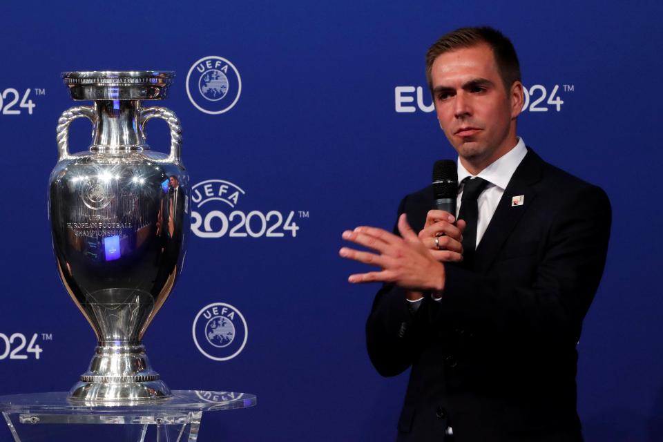  German ambassador Philipp Lahm stands alongside the trophy in Nyon