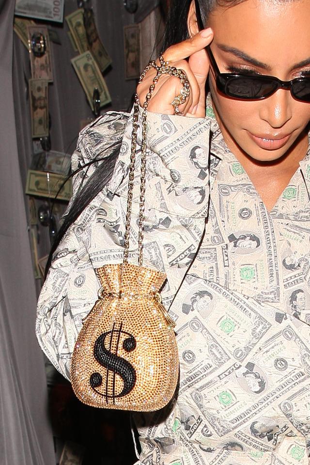  Kim completed the look with a sparkling dollar bill bag