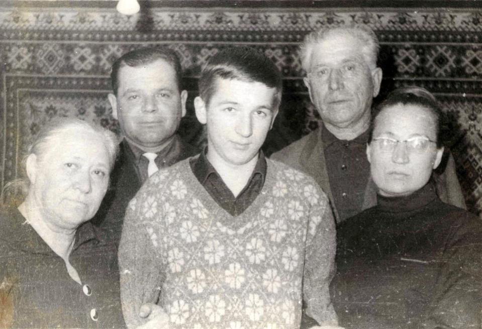  Skripal, centre, with his family including his mother and father, first and second on the left of the picture