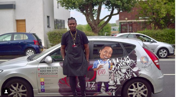  Edwards poses alongside his Smart car that takes him around the country