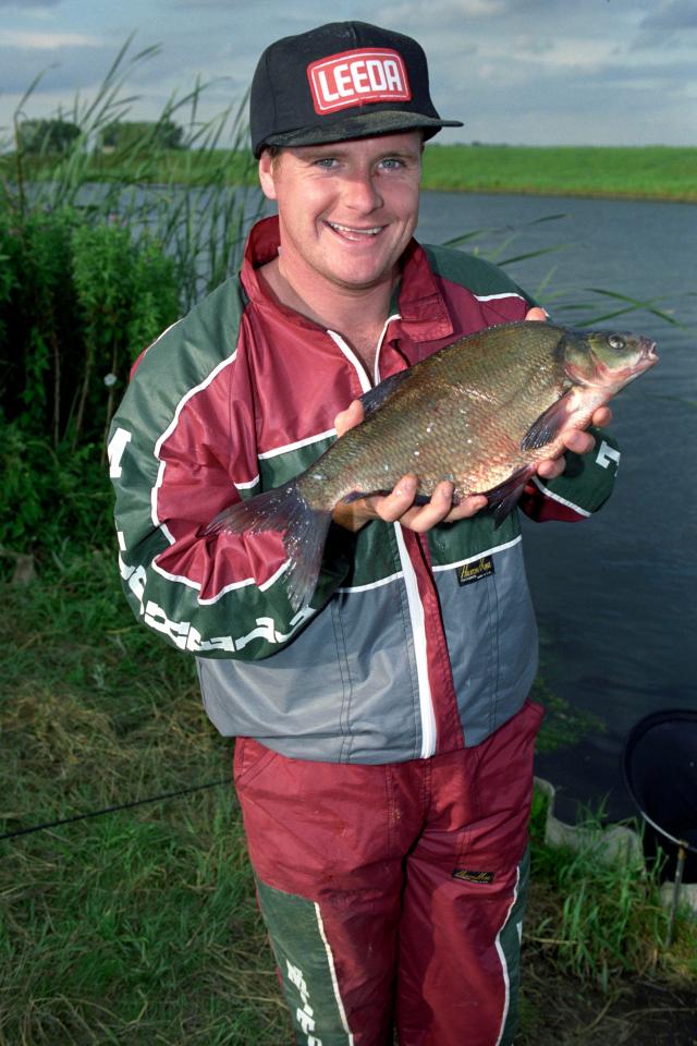  Gazza shows off a catch and is one of many footballers to love fishing