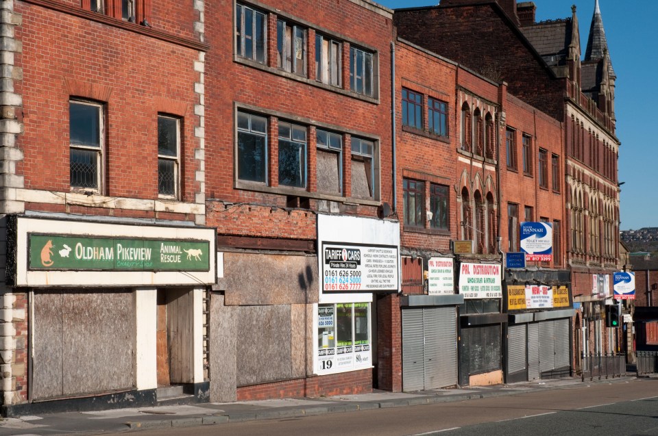 A row of empty shops in Oldham. All retailers whose properties are rated at below £51,000 will get a third off their bills under the Chancellor’s plans