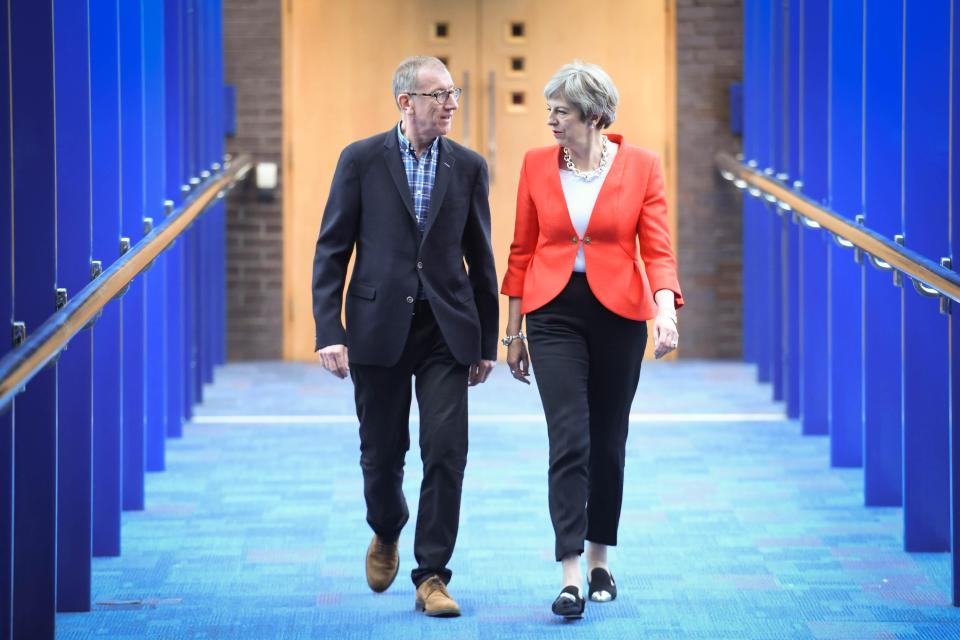  Theresa May and her husband Philip stride into Conference