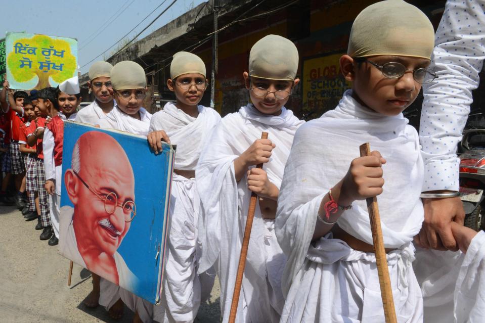  Schoolchildren dressed as Gandhi mark his birth