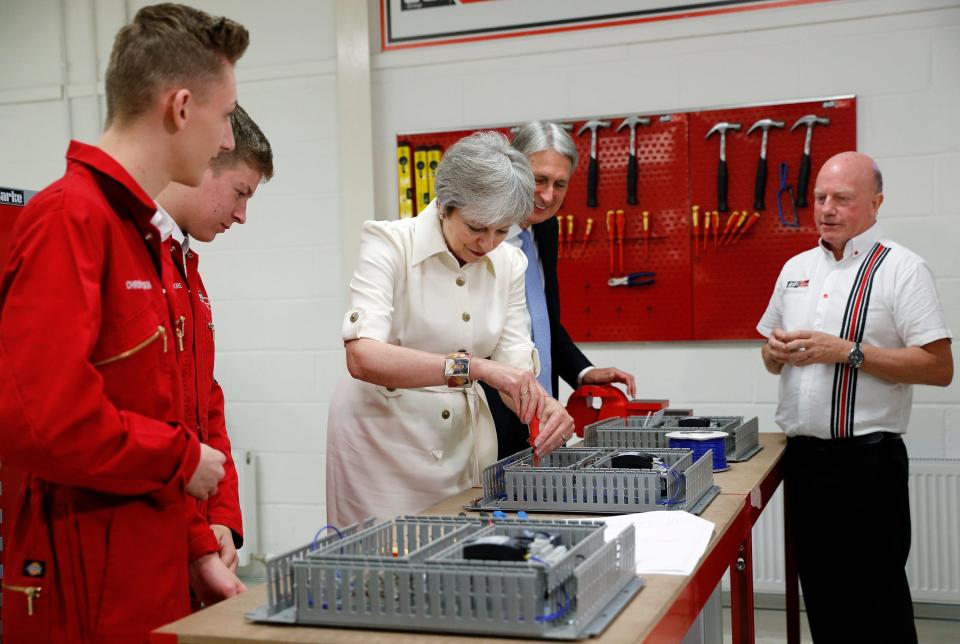  Mrs May visited an engineering firm with Philip Hammond yesterday