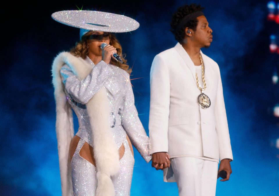  Coordinating with Jay Z, who was in a white suit, Beyonce's shimmering bodysuit sparkled under the stage lights