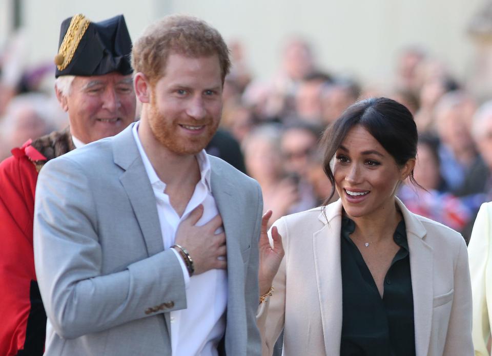  The Duchess of Sussex paired the green outfit with nude heels and a light pink coat by Georgio Armani