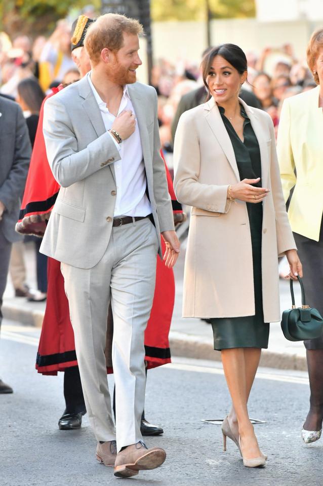  Meghan Markle wore a green leather skirt by Hugo Boss for her first royal visit to Sussex today - and matching bag costing £1.7k