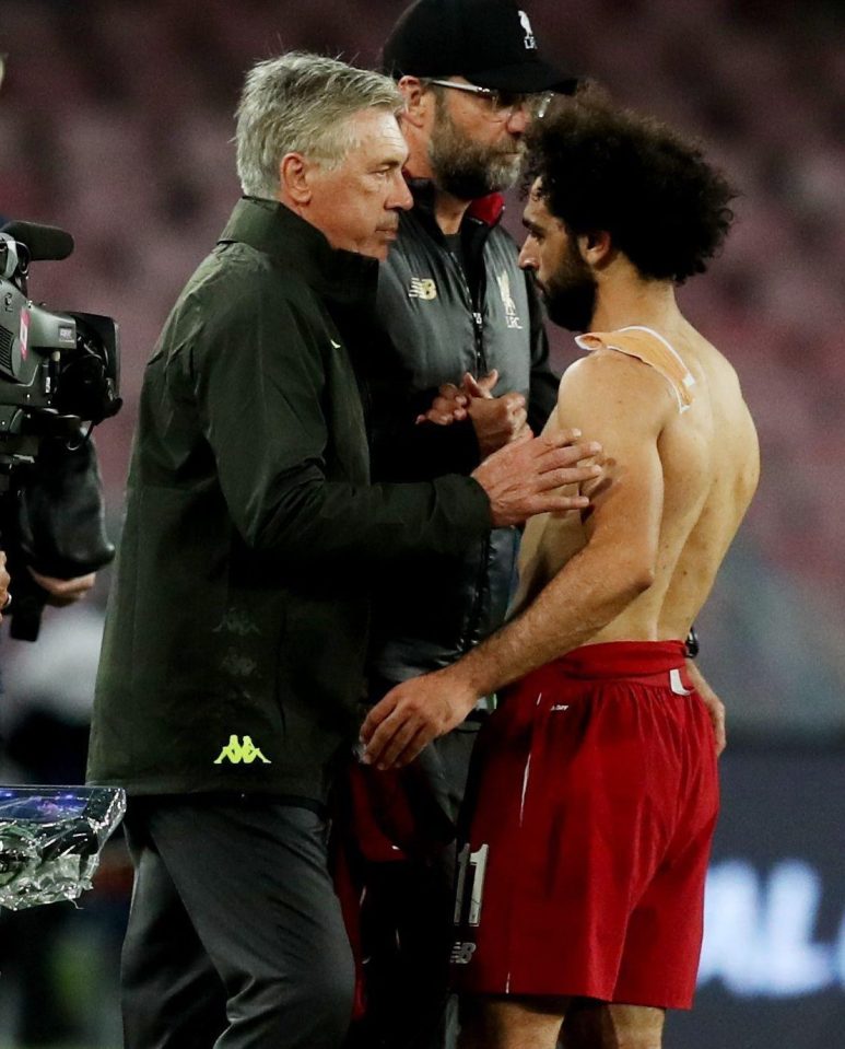  The Egyptian, right, is clearly still having discomfort with the shoulder - which he injured in the Champions League final