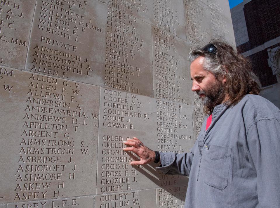  Fighting back tears, artist Rob Heard touches the names of the heroes that inspired his WW1 tribute