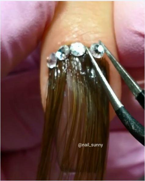  Crystals are added to the base of the nails