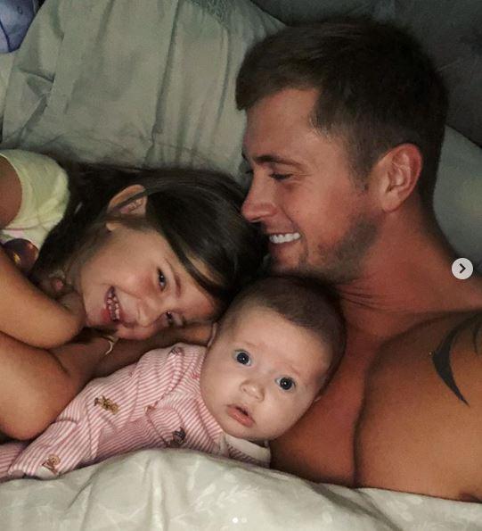  Dan cuddles up to daughters Ella and Mia