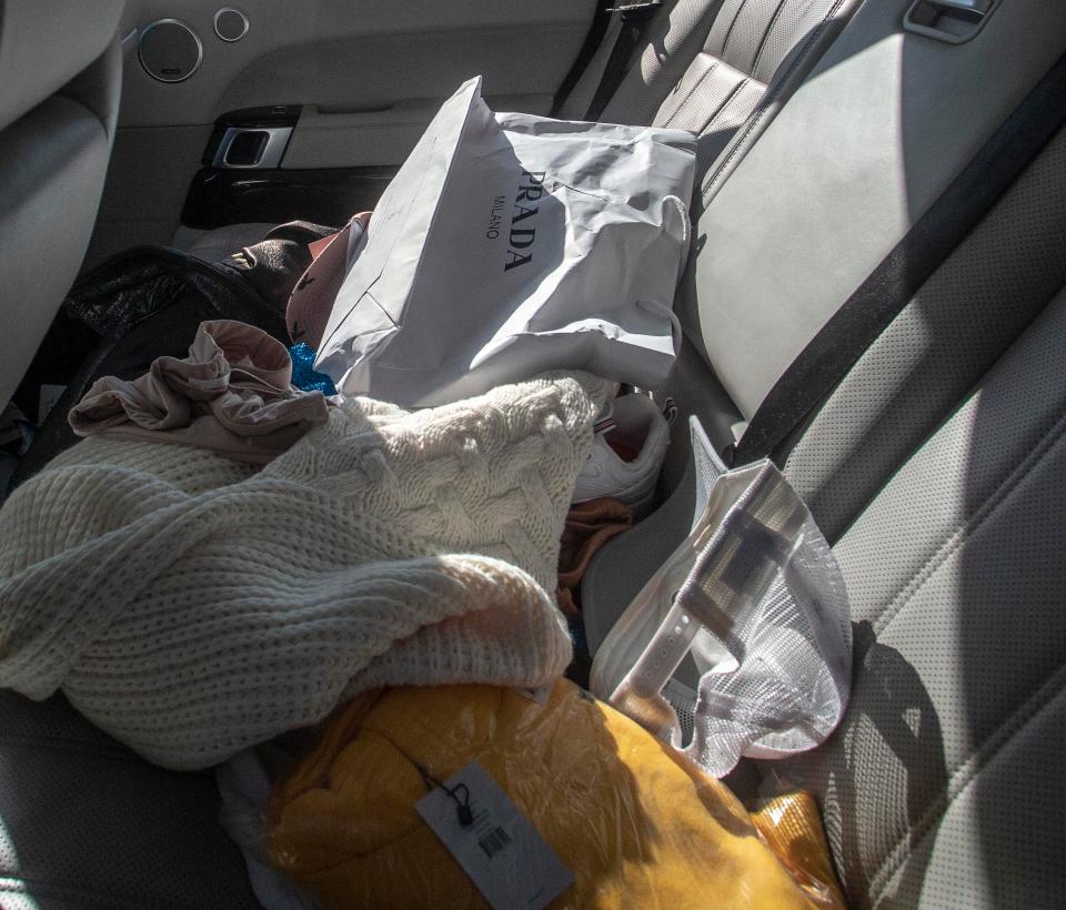  A crumpled Prada bag and scattered clothes were spotted in the back of Katie's crashed car