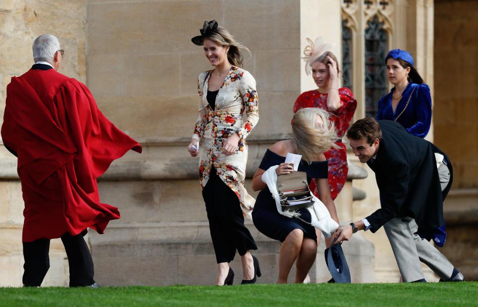  Numerous wedding guests giggled as they tried to stay composed in the winds