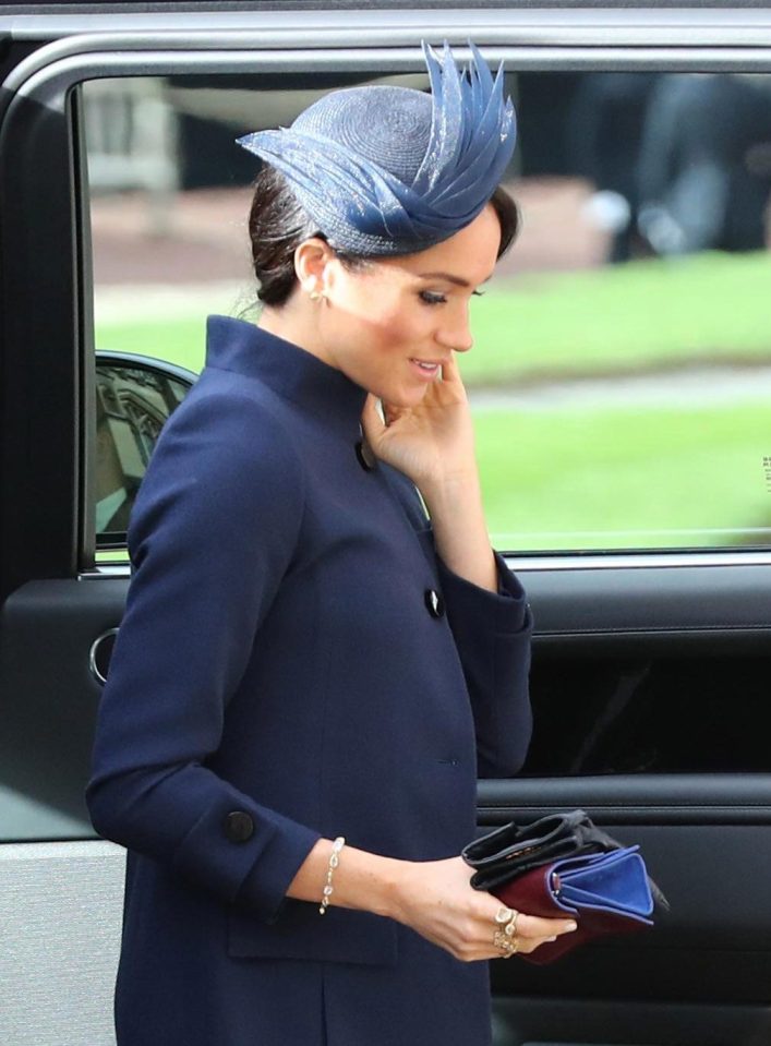  Meghan Markle was seen holding a pair of leather gloves as she arrived at Princess Eugenie's wedding