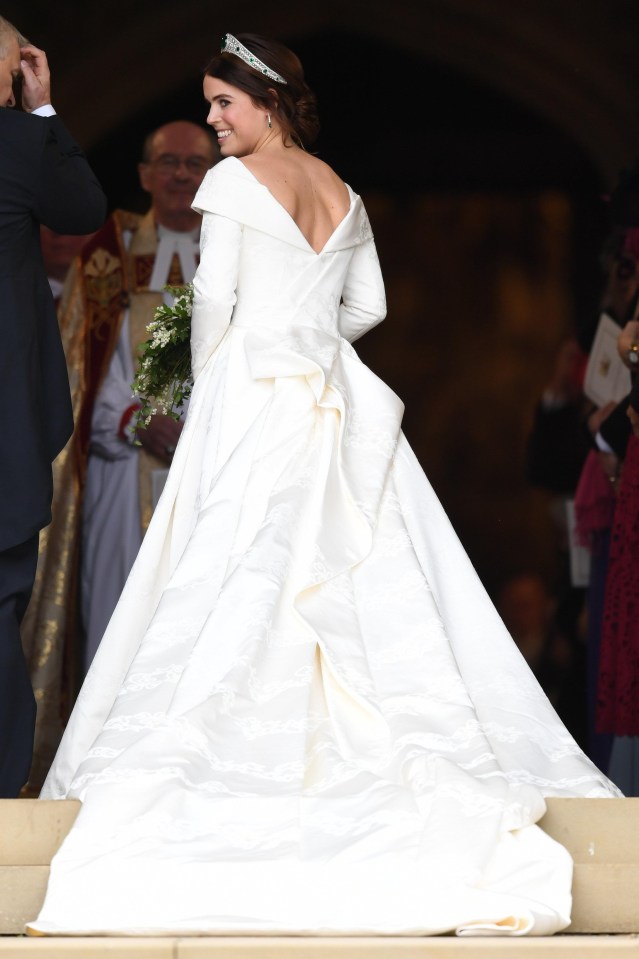 The princess wore a tiara from the Queen’s collection, but no veil – as guests struggled to keep hold of their hats in the wind