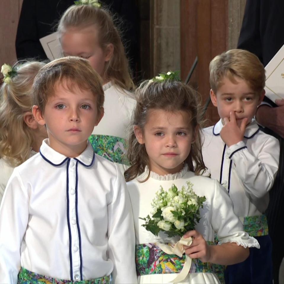  George walked behind Robbie Williams' daughter Teddy (front right)