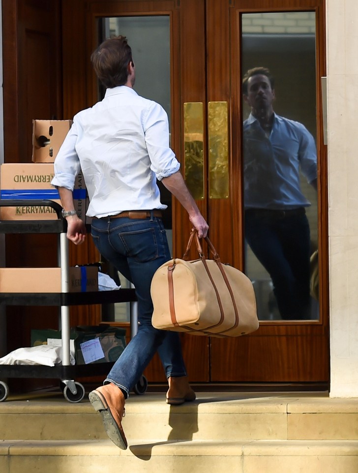 Pippa’s husband, James, pictured running into the Lindo Wing today with a bag