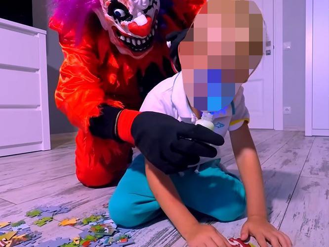  Still from YouTUbe video showing a child being drugged by a killer clown before he is bound and gagged - the video is fake but the content disturbing