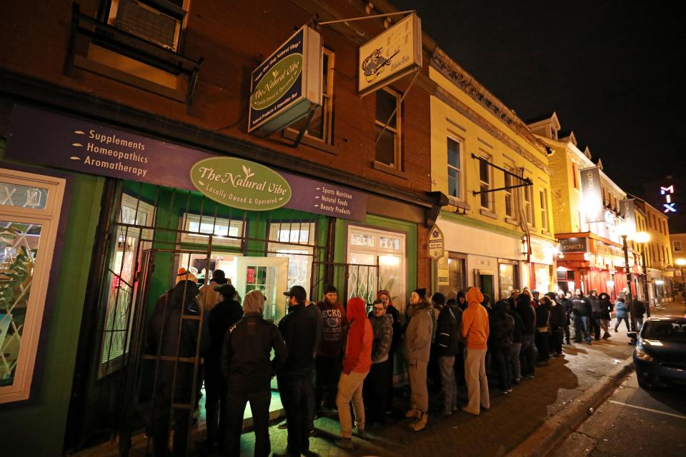  Customers line up outside the Natural Vibe store after legal recreational marijuana went on sale in St John's, Newfoundland and Labrador