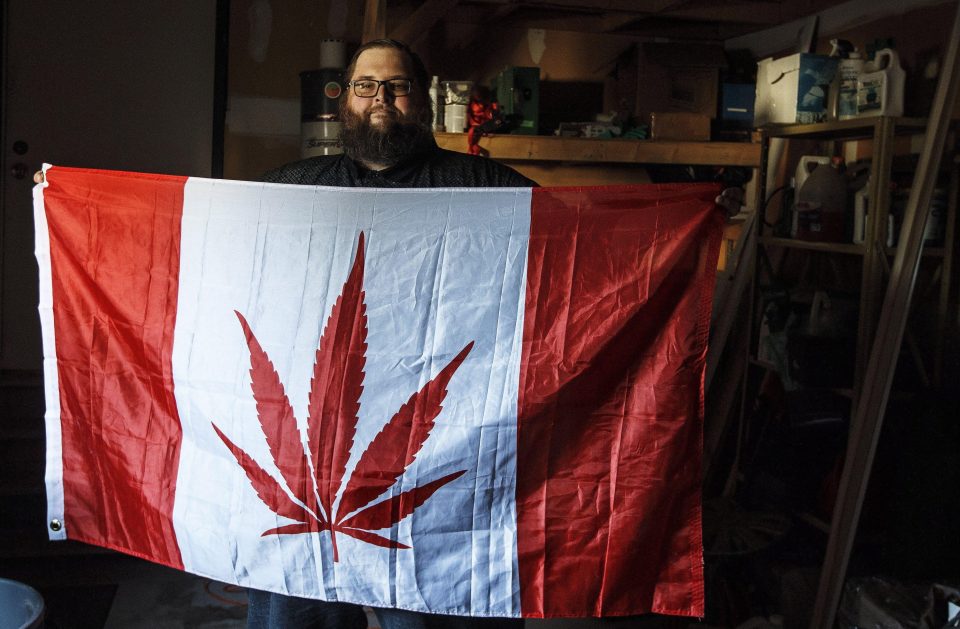  Trevor Pott clutches a Canadian flag with a cannabis leaf imprinted on it