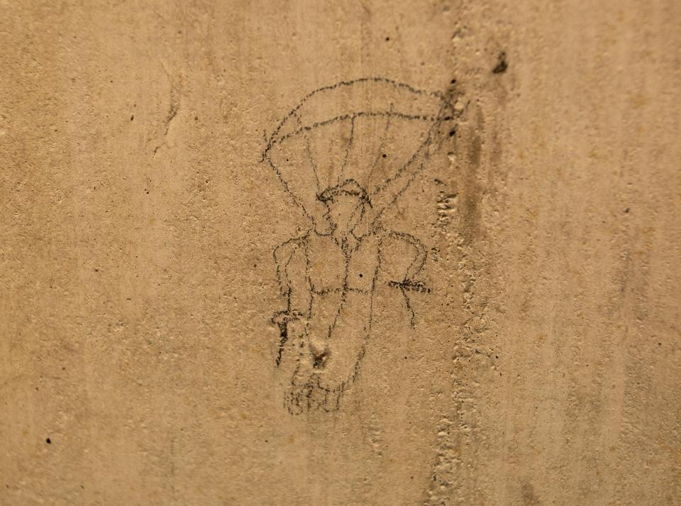  A soldier parachuting is etched onto one of the walls