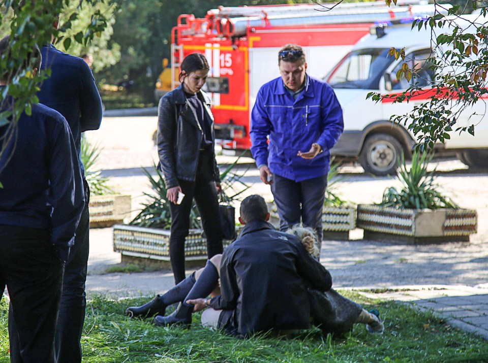 A rescuer carries an injured victim of a blast at at a college in the city of Kerch