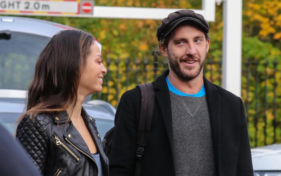  Seann Walsh and Katya Jones smile at each other as they leave rehearsals