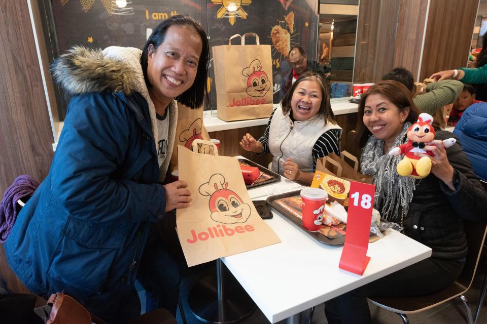  People look delighted to have their hands on the chicken