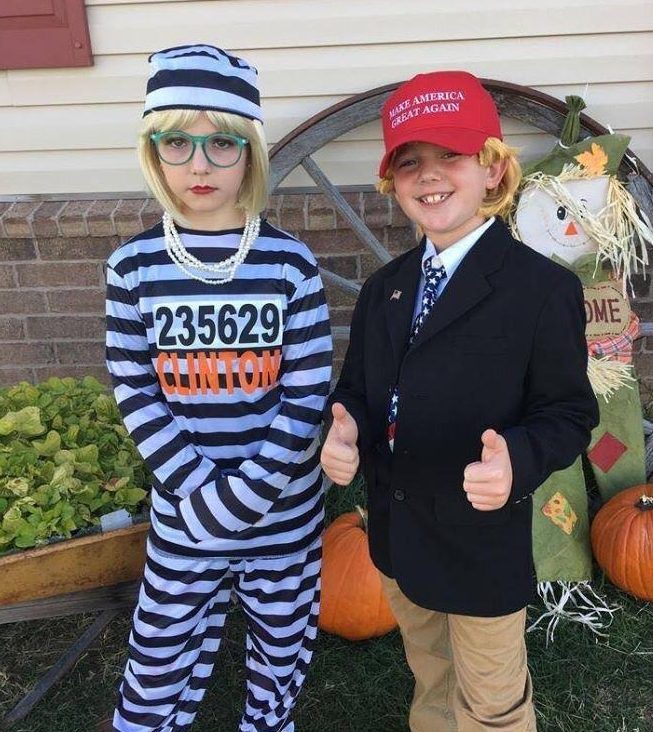  Donald Trump becomes the subject of another costume, as the child on left is dressed like a prisoner labelled 'Clinton', while 'Trump' smiles on the right