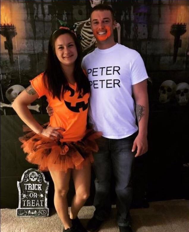  The girl dressed herself like a pumpkin while the boy put orange paint on his mouth to look as if he was eating the pumpkin