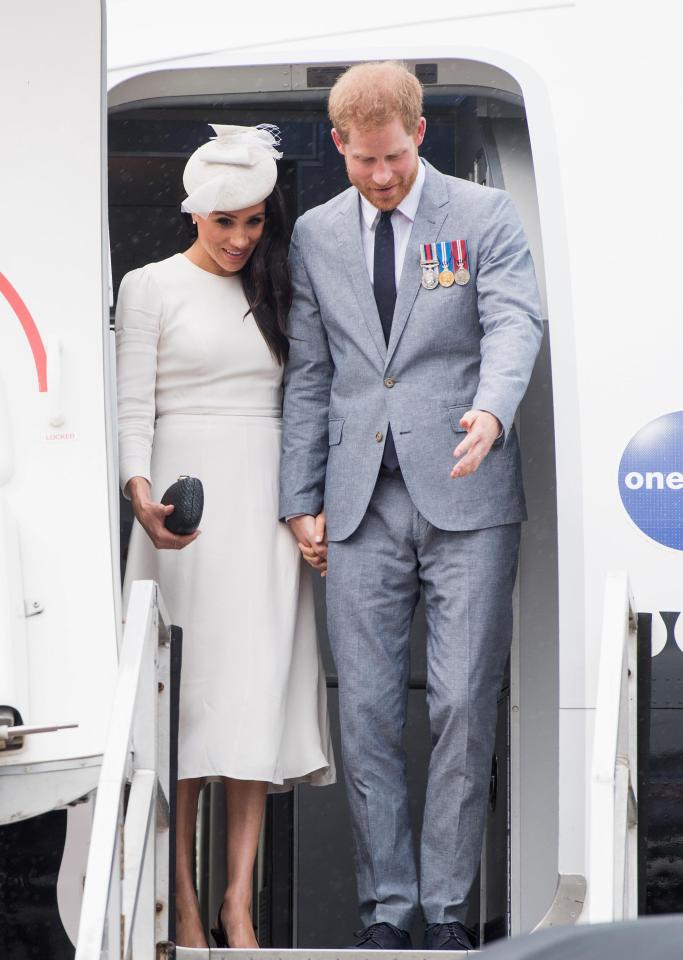  Prince Harry and Meghan disembark from their plane on their arrival in Suva, Fiji