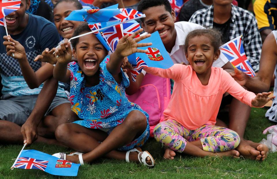  Local children smile and wave flags as Harry and Meghan arrive in Fiji