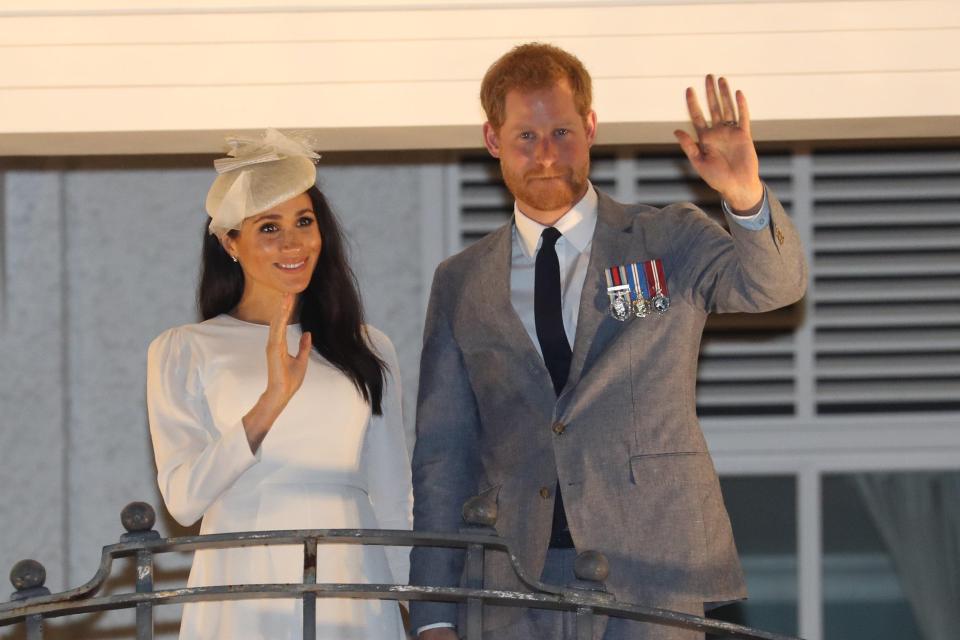  Harry and Meghan wave to crowds from the balcony of their hotel after the ceremony